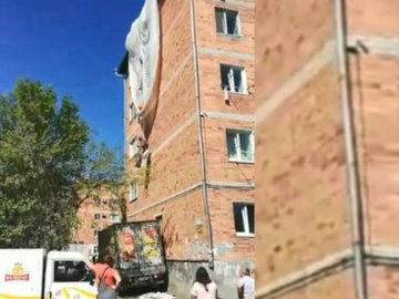 Десантник с парашютом повис на фасаде пятиэтажного дома